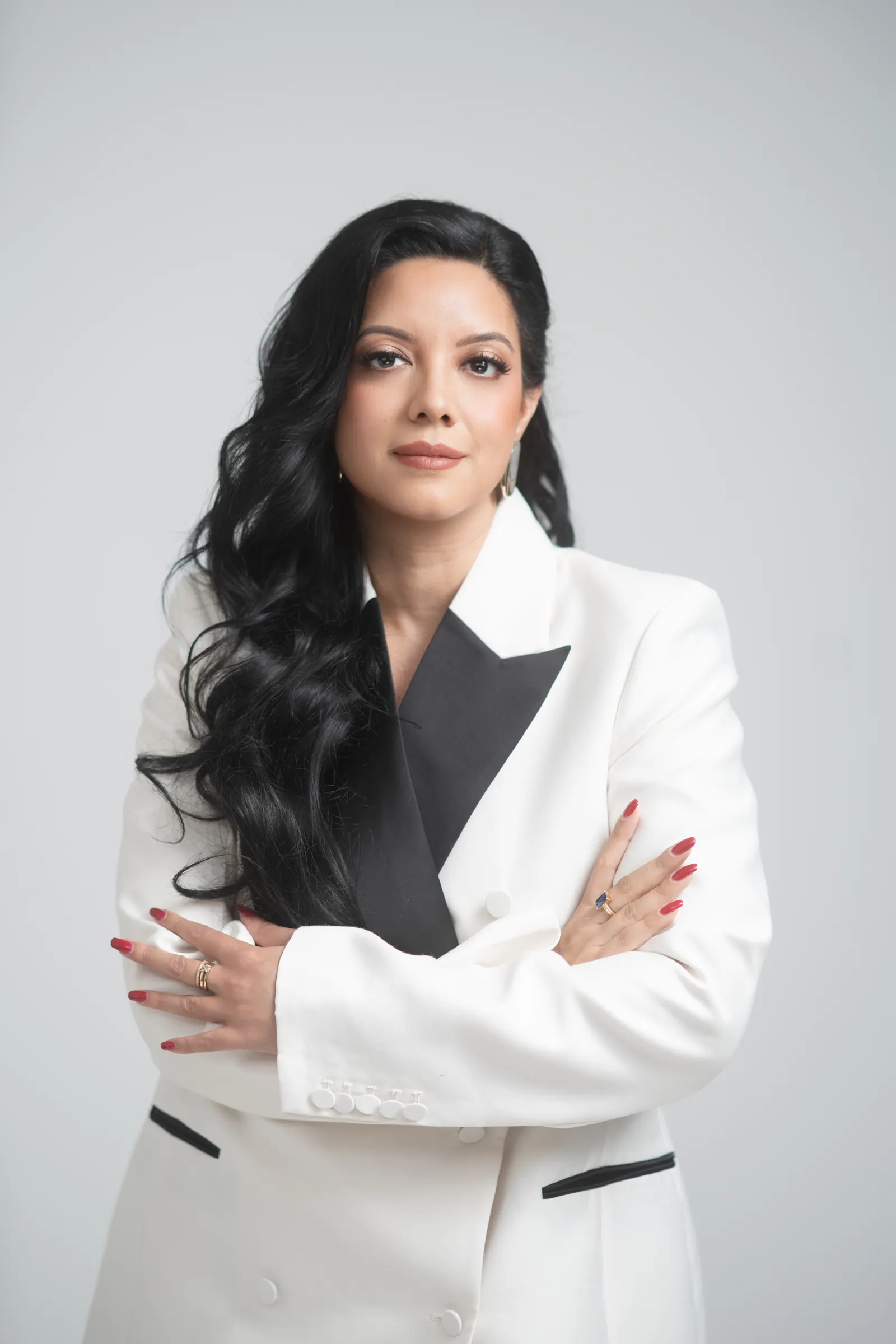 Priscilla Laclé, founder of Oriyé, in a white suit with her arms crossed